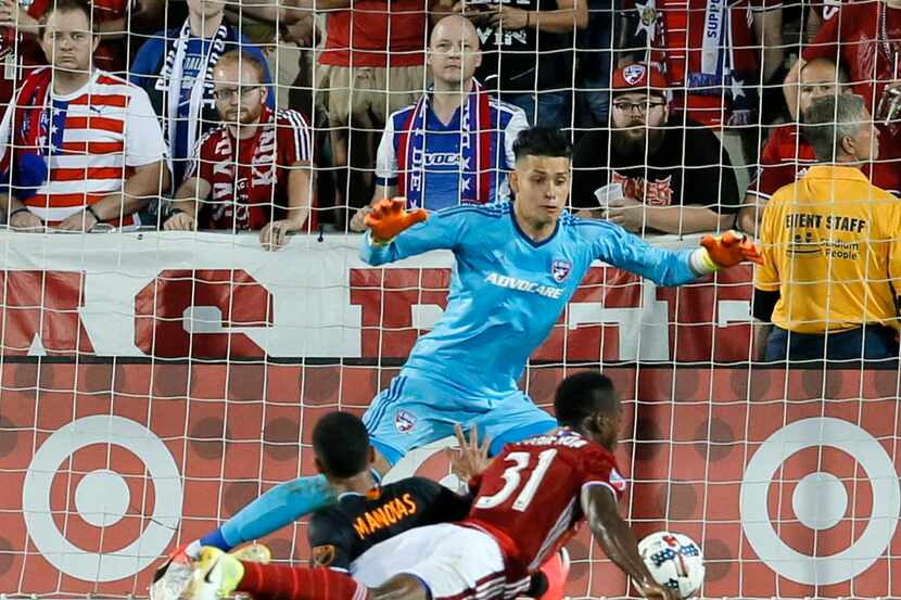 FILE - In this May 28, 2017, file photo, FC Dallas defender Maynor Figueroa (31) helps...