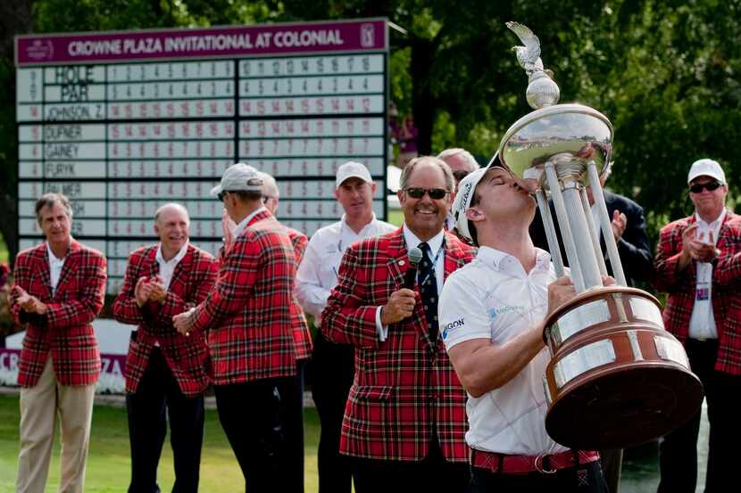 Zach Johnson holds up and kisses the trophy after winning the Crowne Plaza Invitational at...