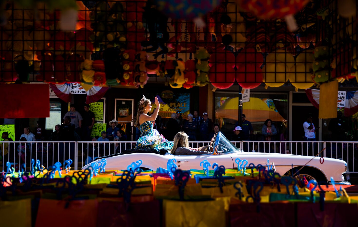 Yamboree Princess Jaici Pilcher rides in the back of a convertible through the festival...