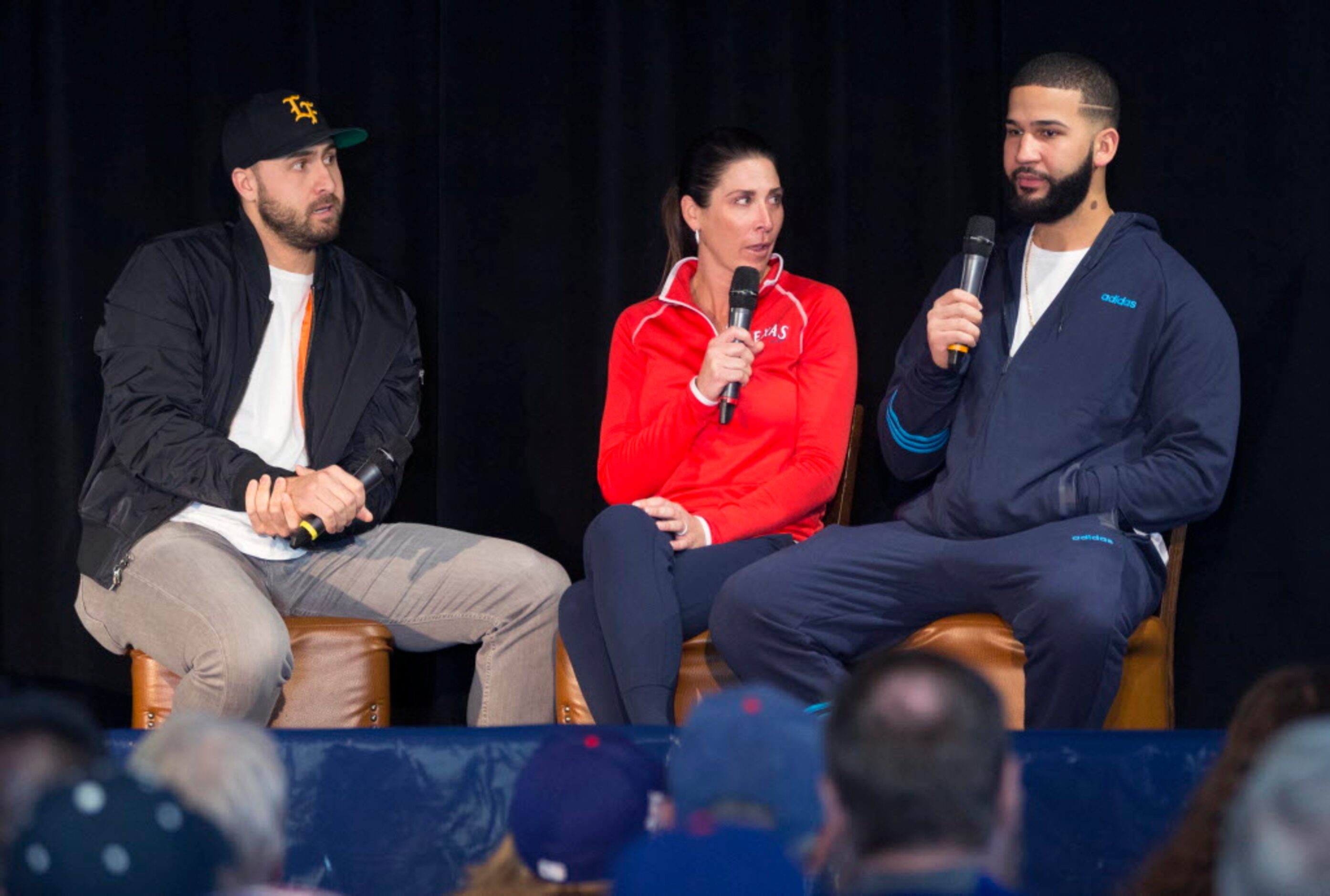 Texas Ranger Joey Gallo, left, and sideline reporter Emily Jones, center, listen to Texas...