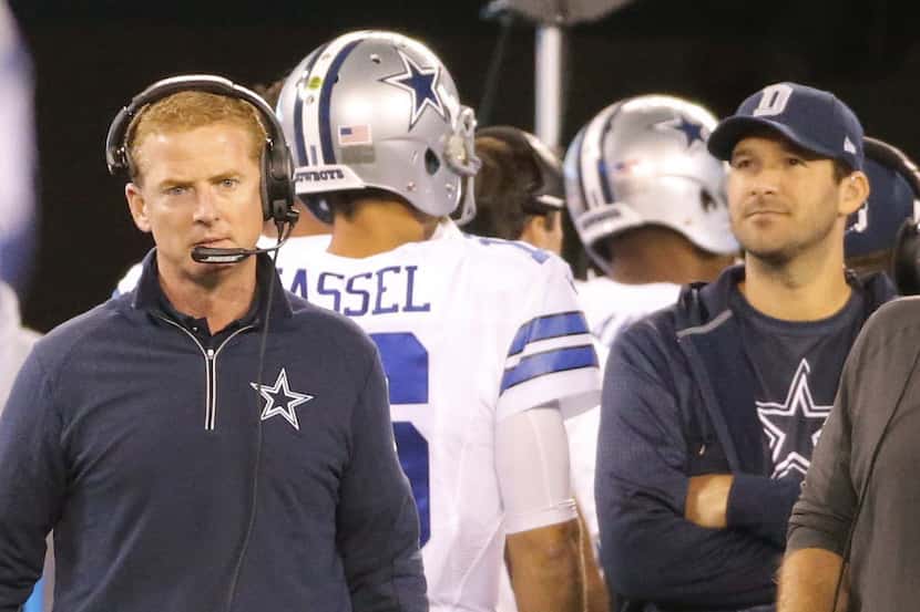 Dallas head coach Jason Garrett, left looks towards the field as quarterback Matt Cassel...