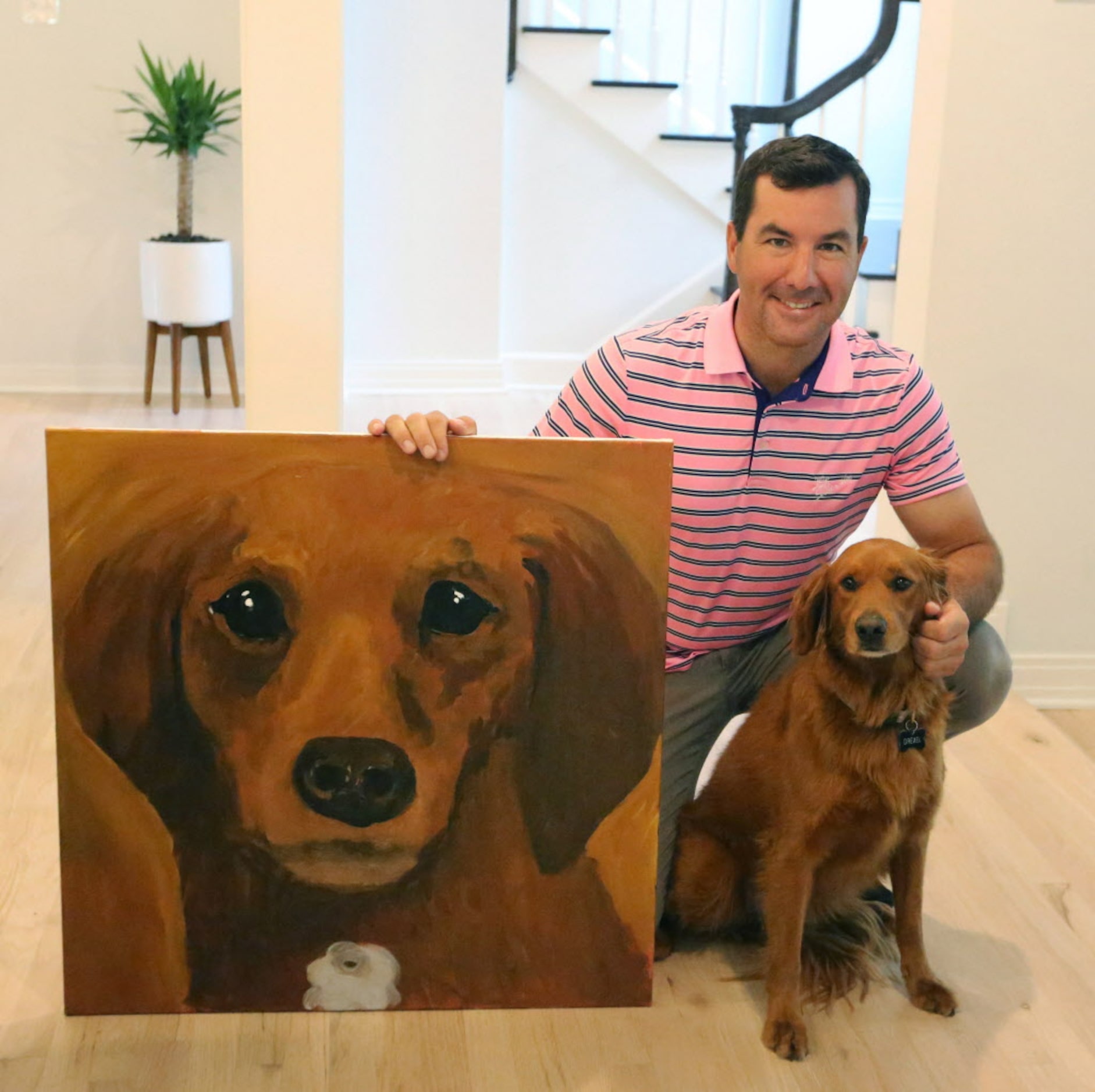 Former Dallas Stars goalie Marty Turco shows a painting of the family dog "Drexel" painted...