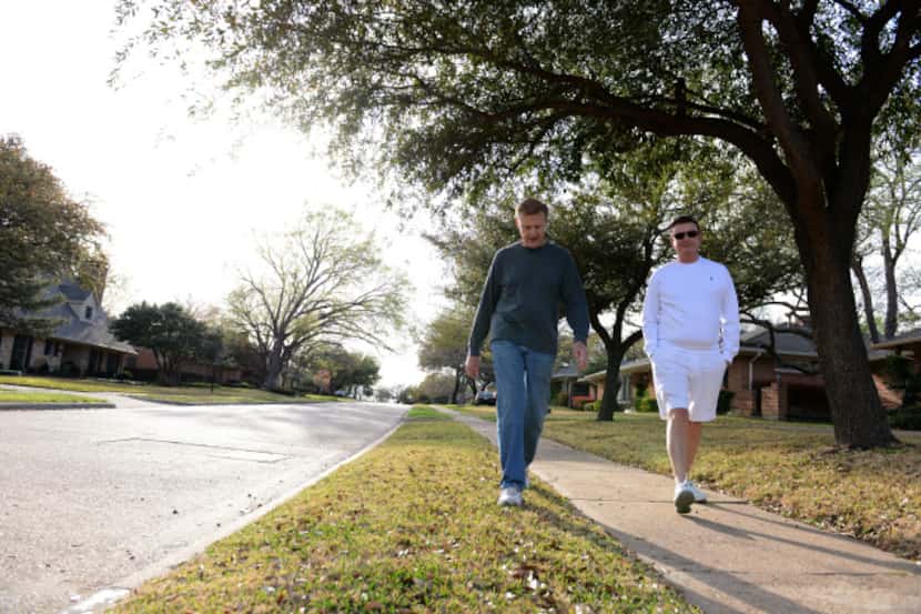 Residents Gene Yarbrough (left) and Steve Logsdon go for an early evening walk along the...