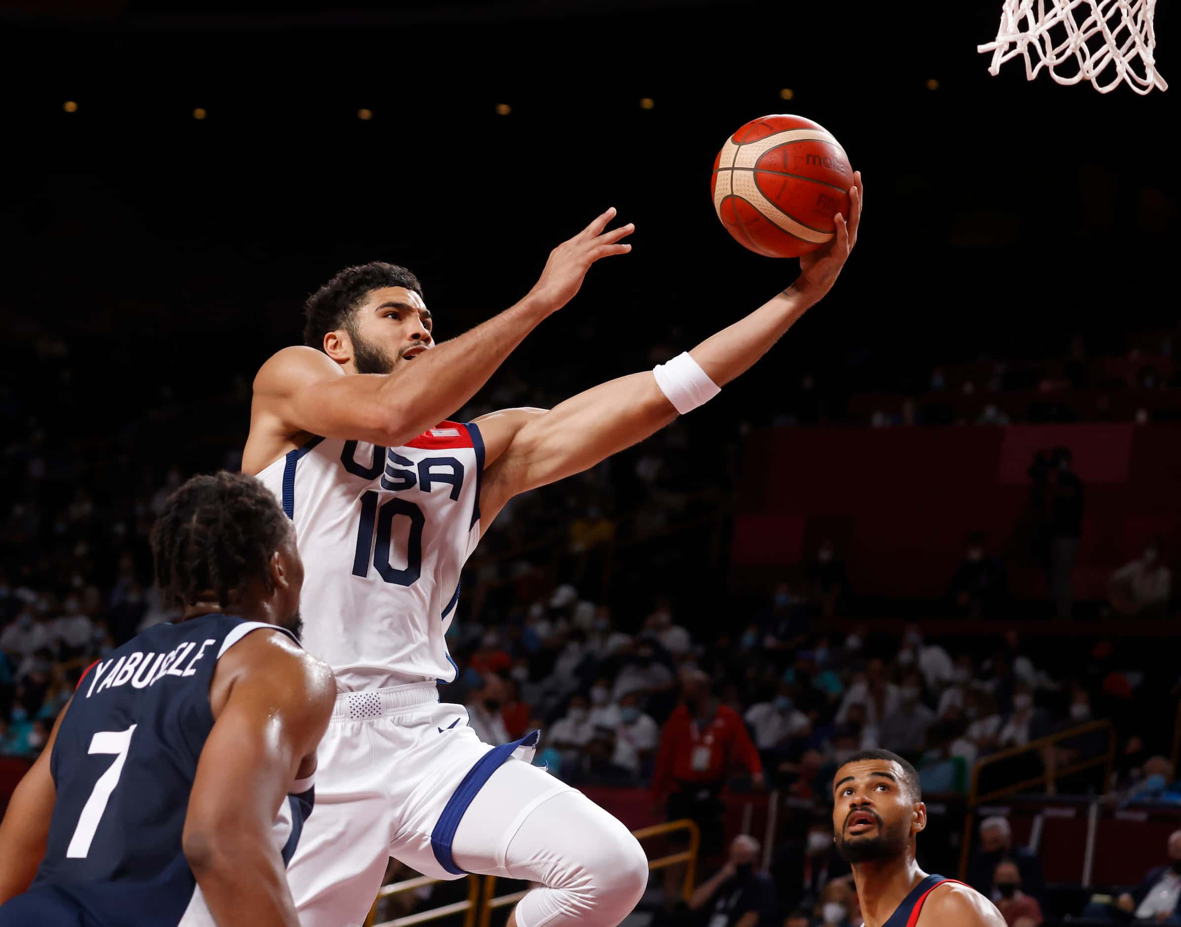 USA’s Jayson Tatum (10) attempts a shot in front of France’s Guerschon Yabusele (7) during...