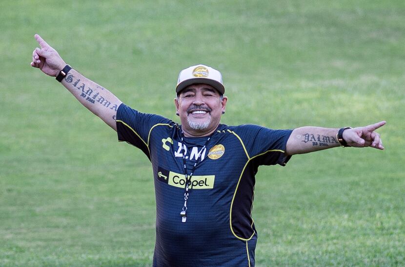 Argentine legend Diego Maradona gestures during his first training session as coach of...