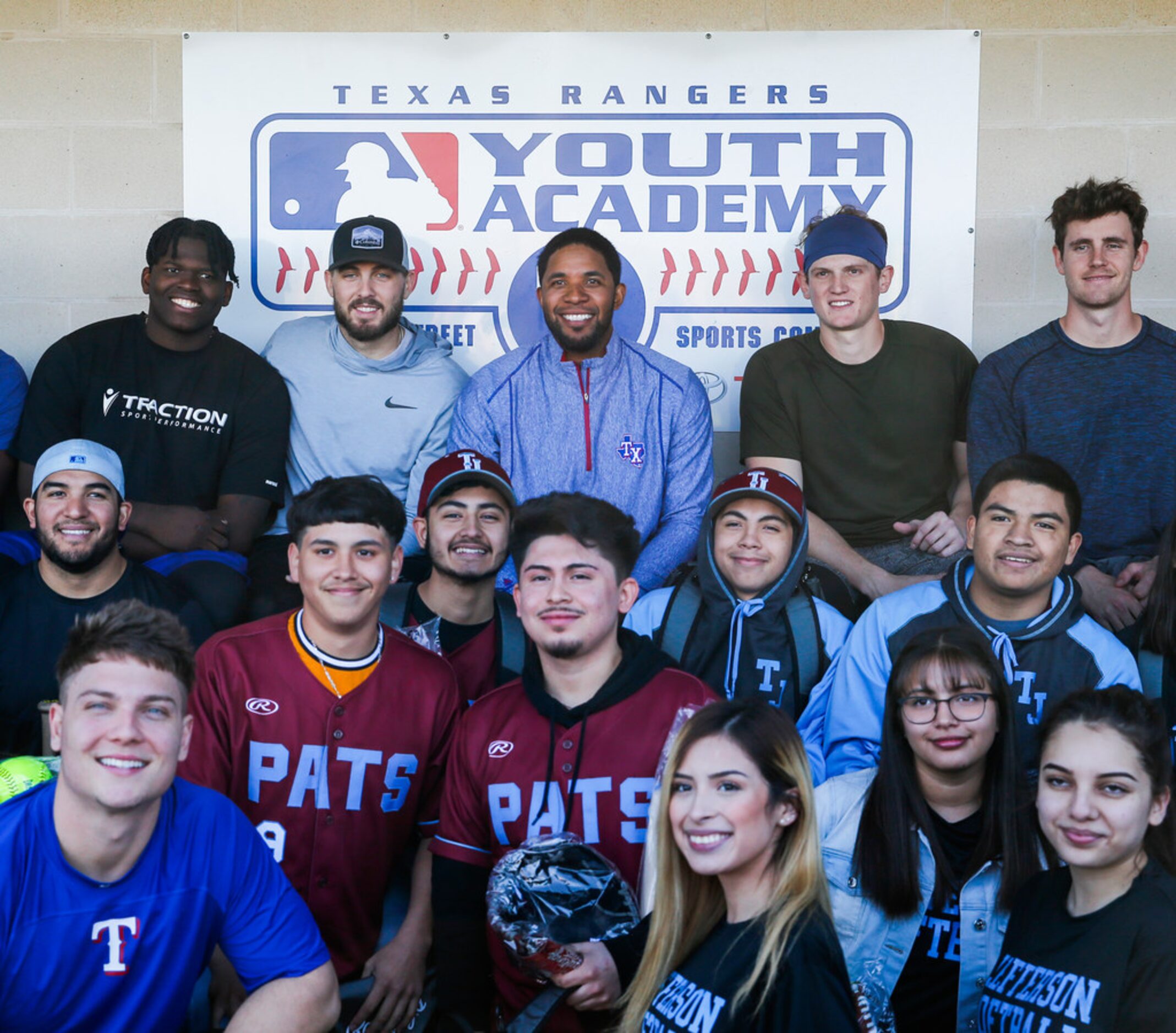 Rangers shortstop Elvis Andrus, seated top center, donates baseball and softball equipment...