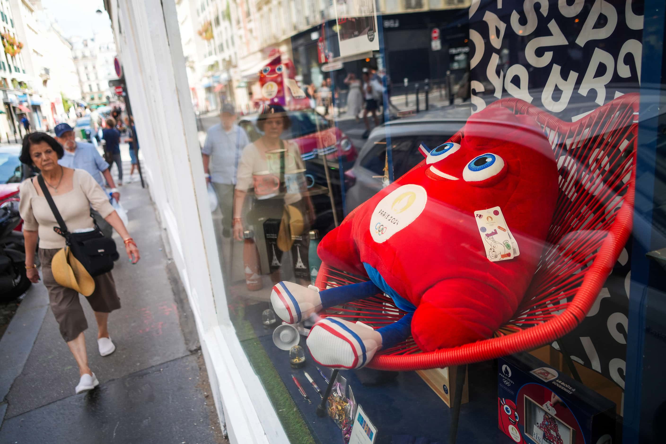A plush version of the Paris 2024 Olympic mascot, Phryge, is seen in a shop window ahead of...