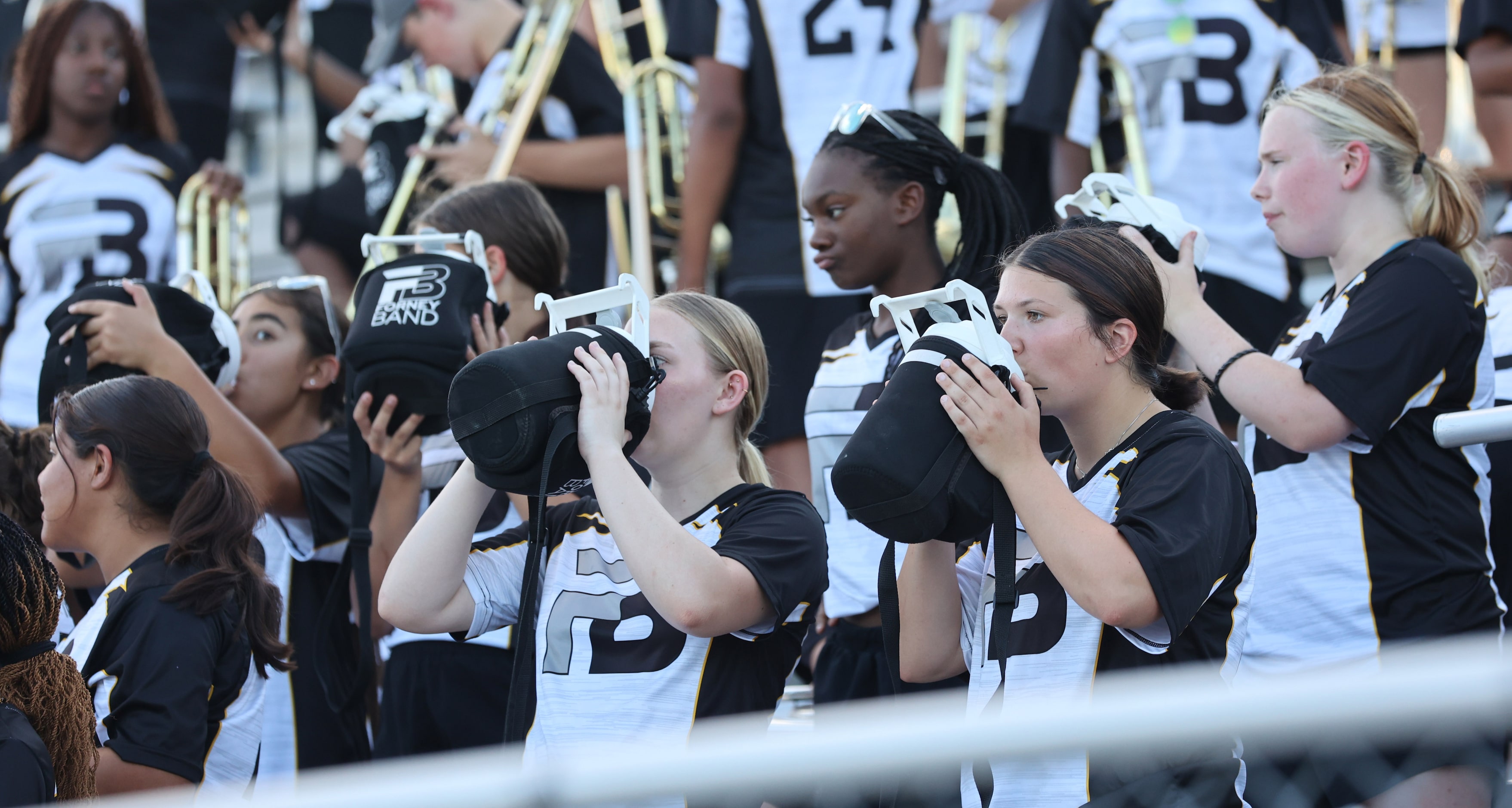 Forney band members gulp water during a break before the first half of a high school...