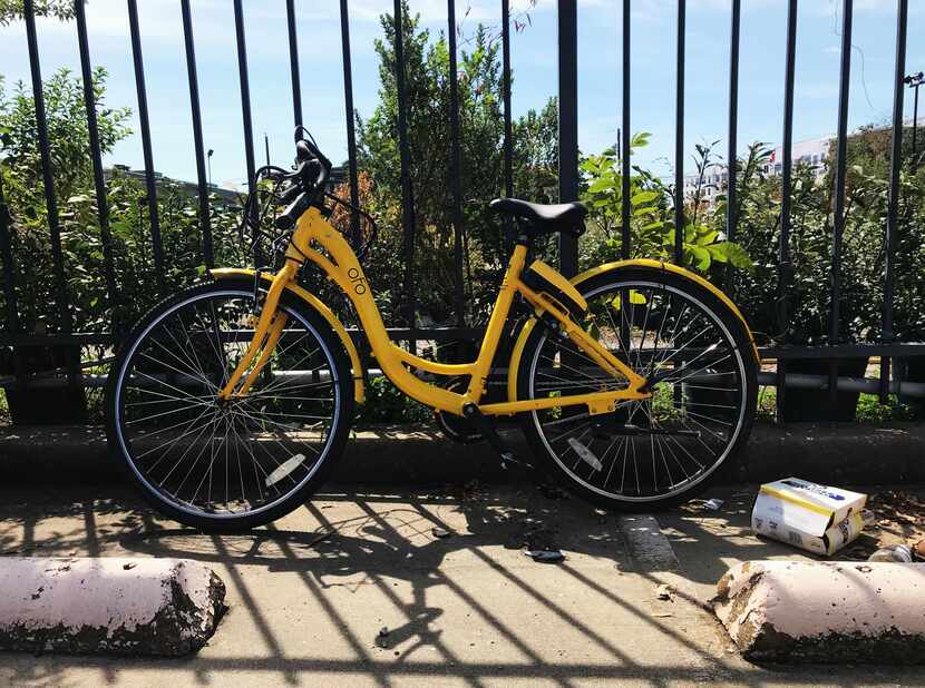 An abandoned Ofo bike in a parking lot in Downtown Dallas. Just imagine if this was a common...