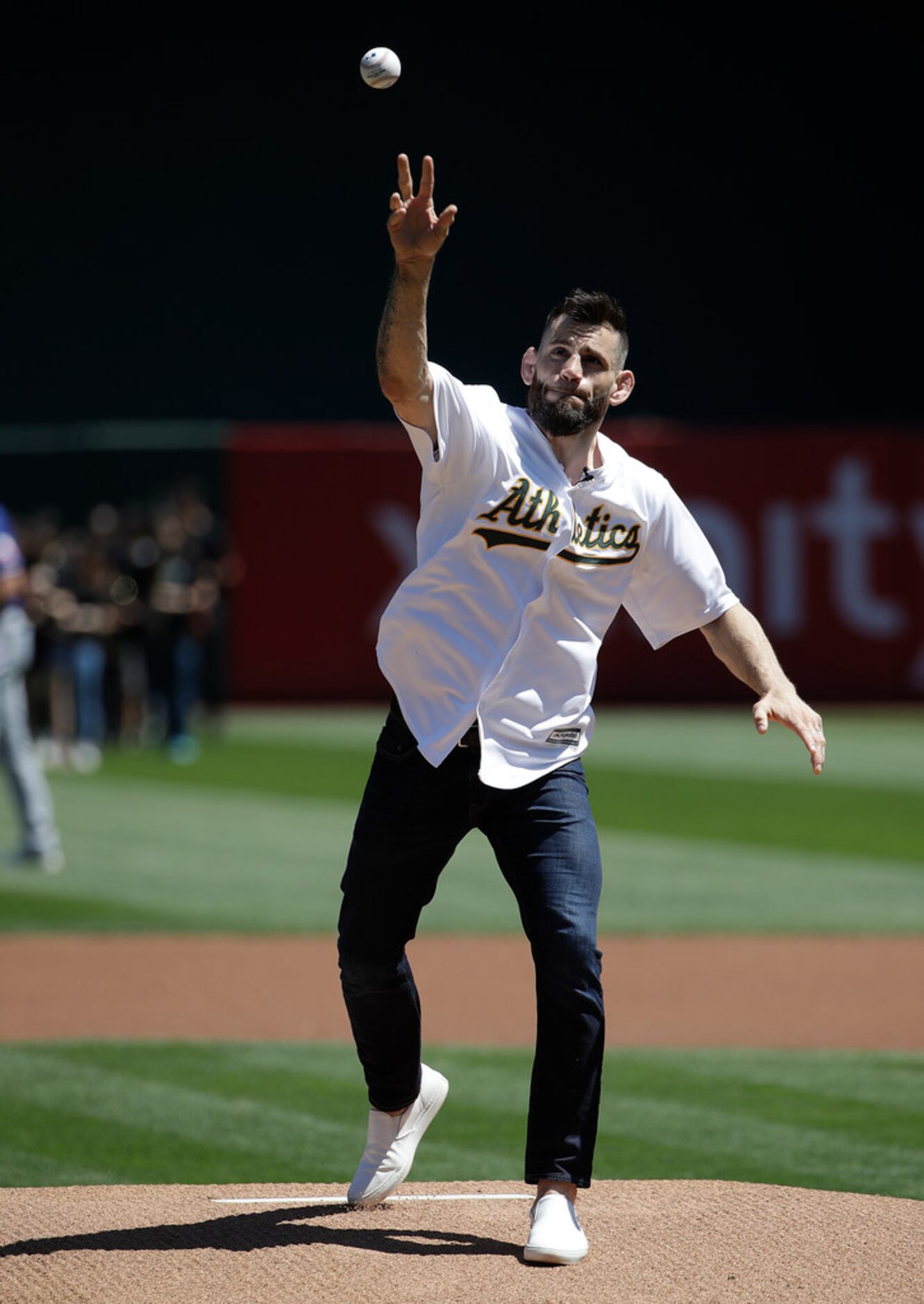 Mixed martial arts fighter Jon Fitch throws out the ceremonial first pitch before a baseball...