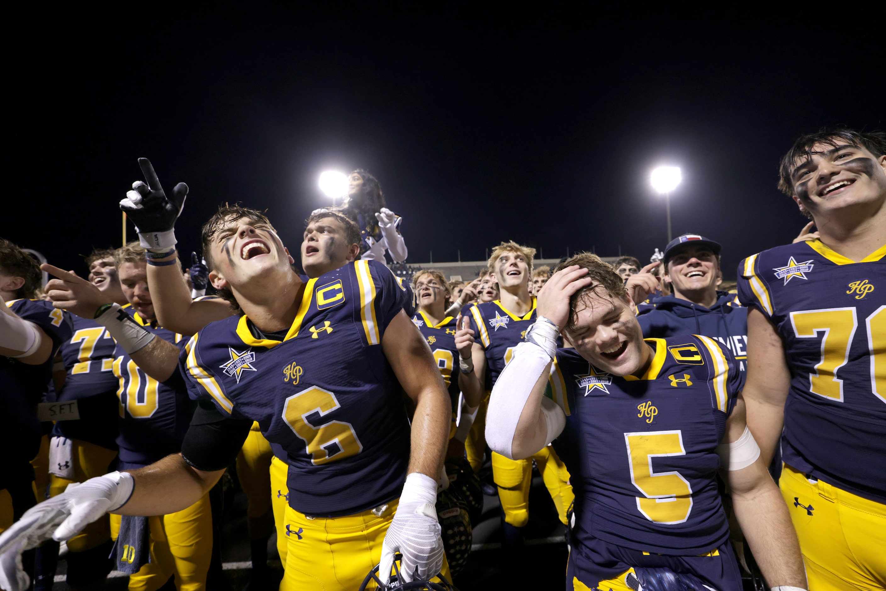 Highland Park players celebrate after winning a football playoff game against Frisco...