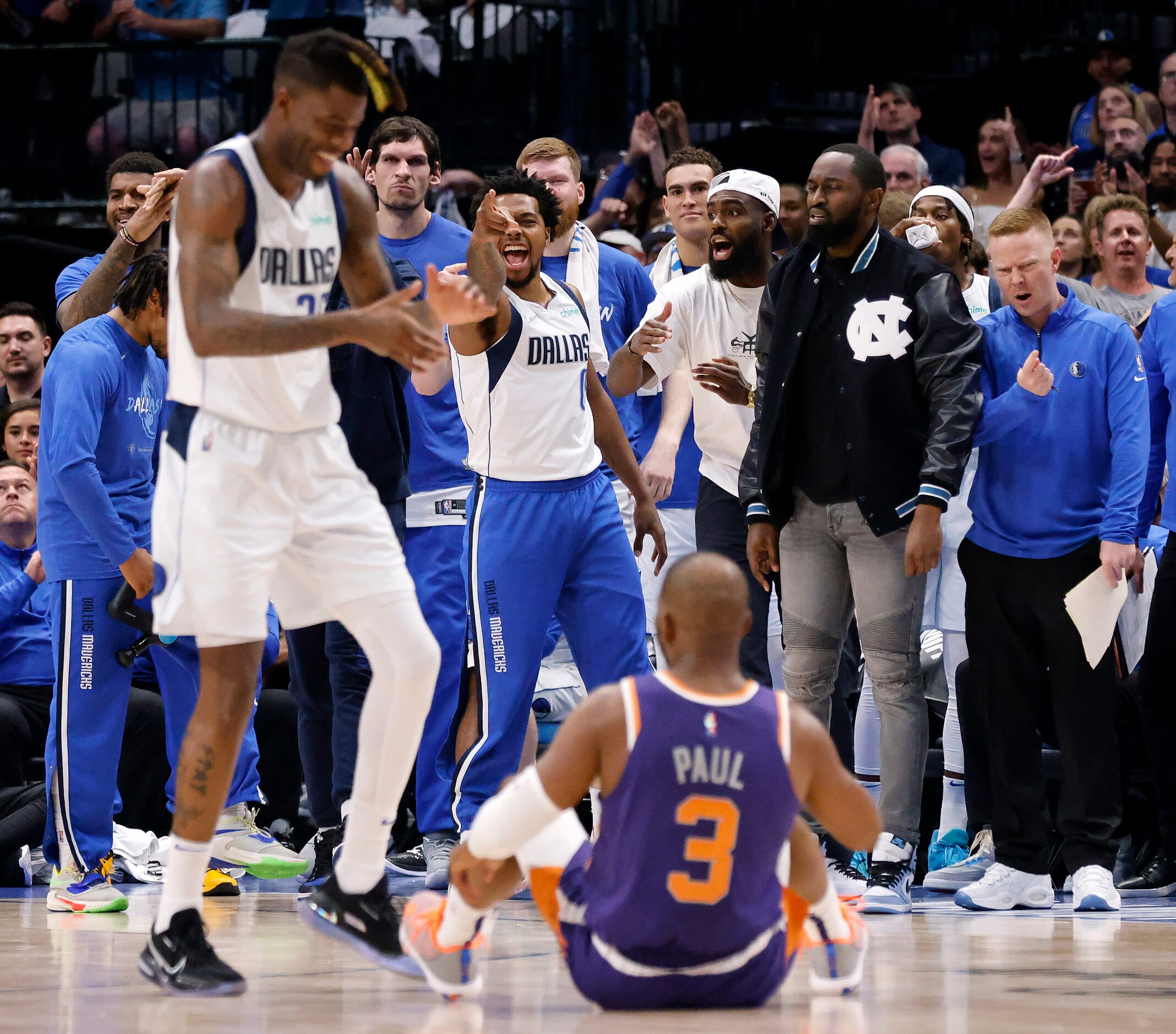 The Dallas Mavericks bench including forward Reggie Bullock (left) celebrate after Phoenix...