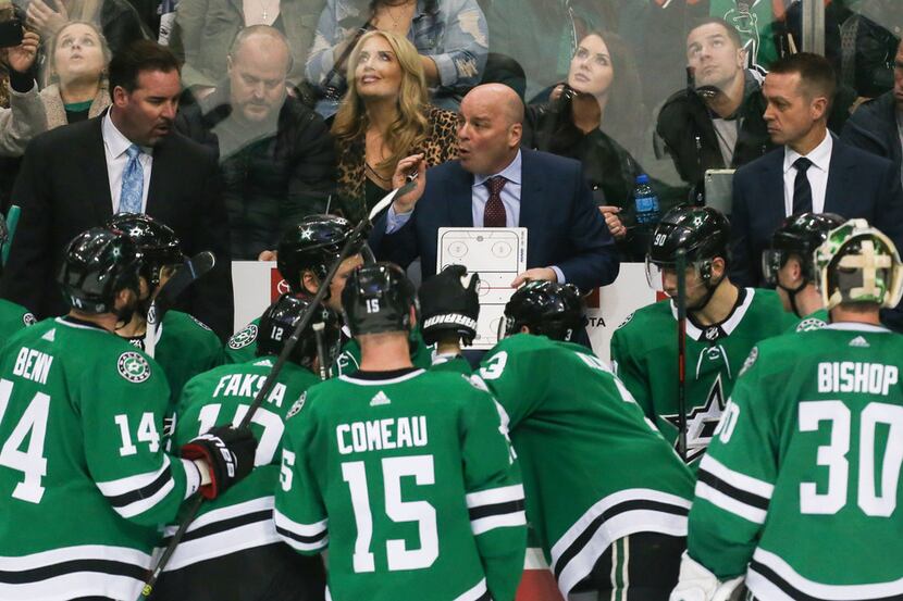 Stars head coach Jim Montgomery talks to the team during a timeout in the third period of a...