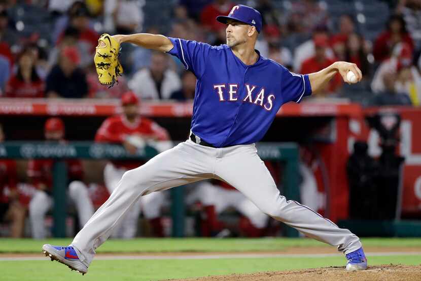 Texas Rangers starting pitcher Mike Minor throws to the Los Angeles Angels during the first...
