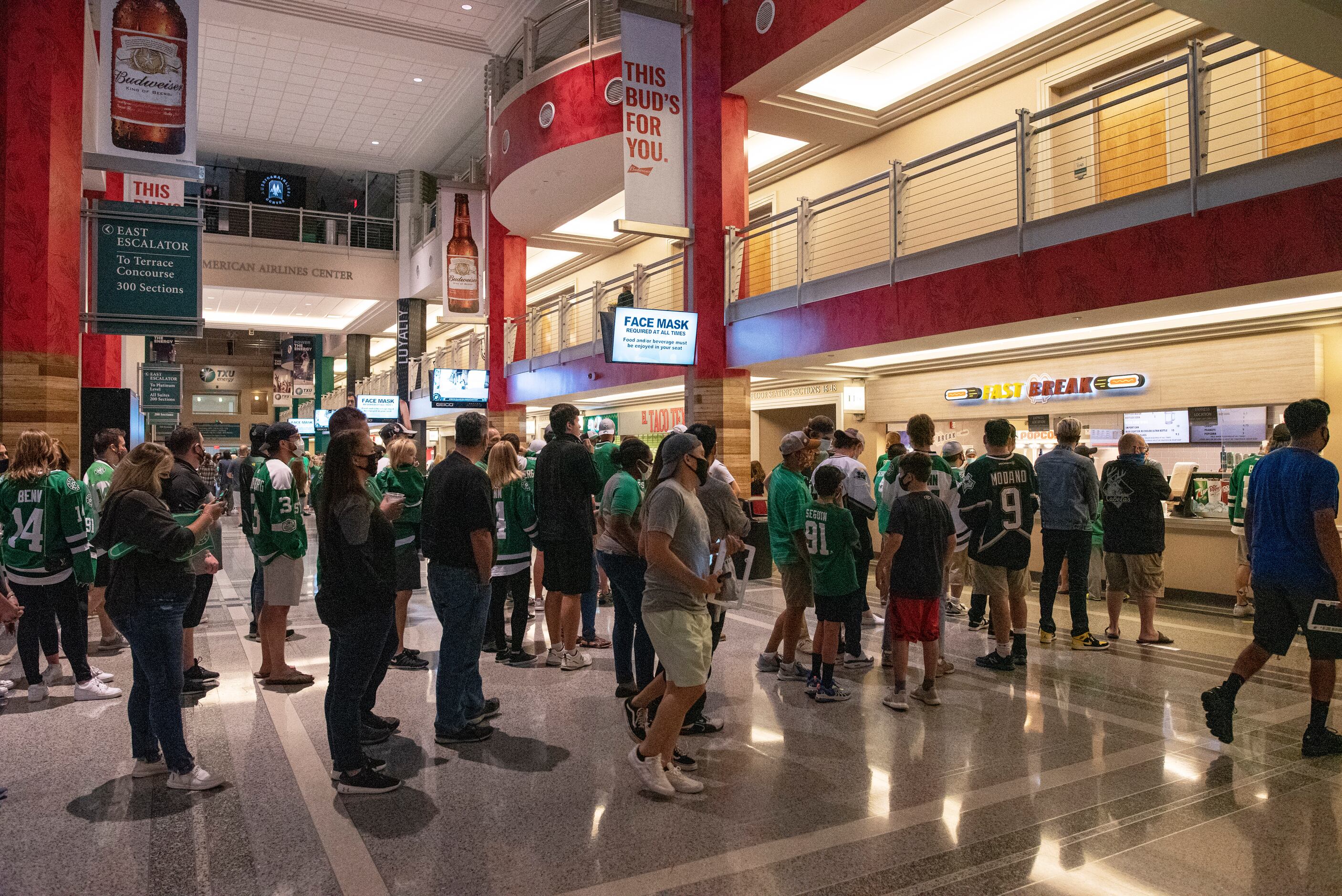 Dallas Stars fans wait in line at concession stands during a watch party at the American...
