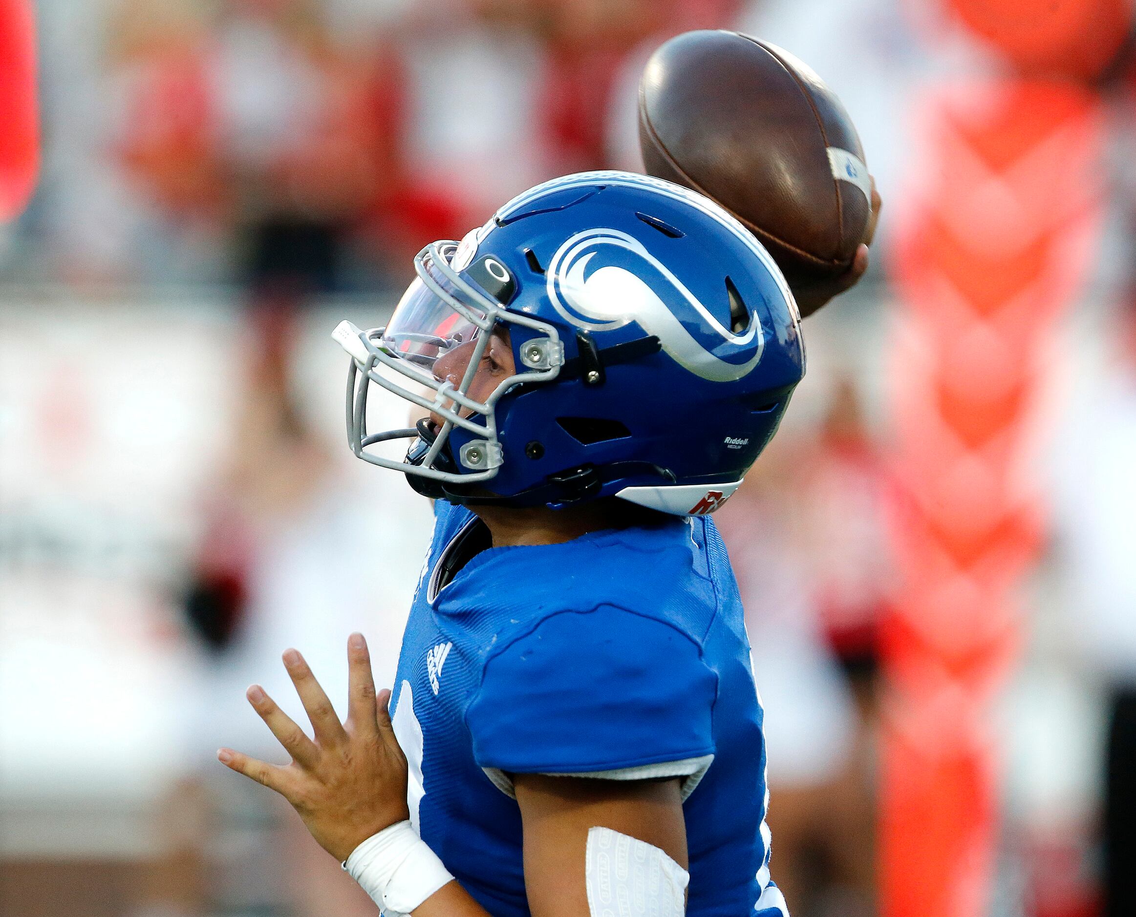 Nolan Catholic High School quarterback Cole Matsuda (10) launches a pass during the first...