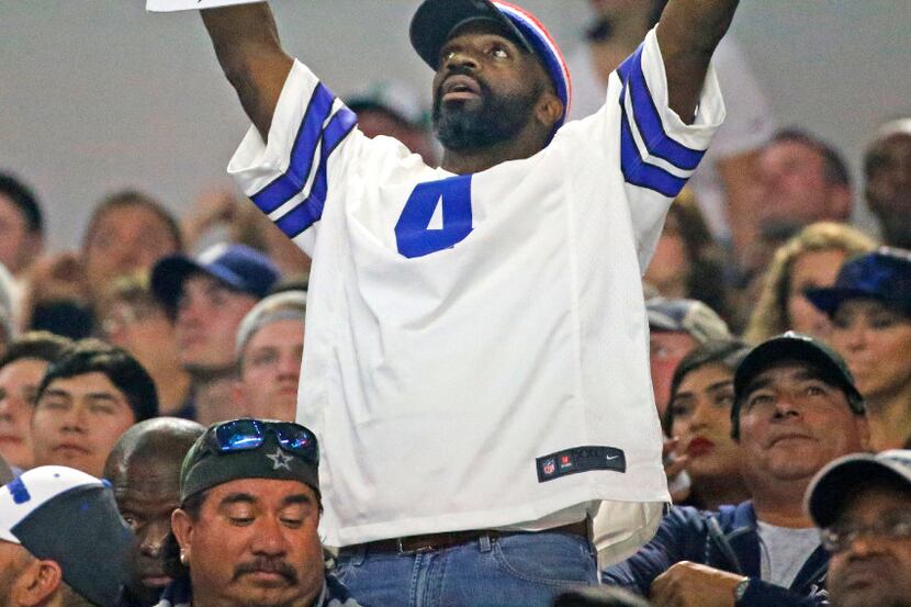 A Cowboys fan holds his hopes high with a sign during the Washington Redskins vs. the Dallas...