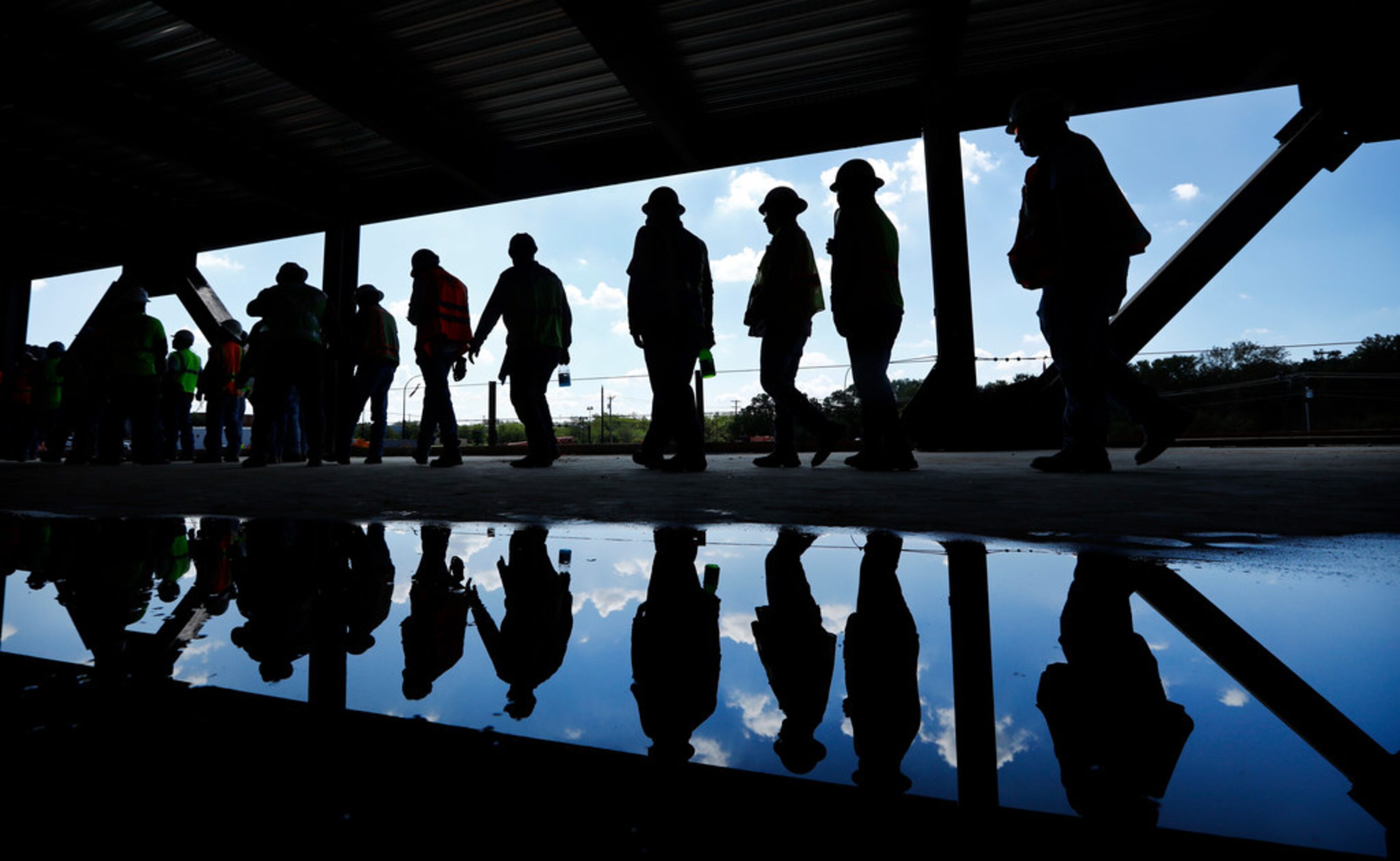 Some of the 900 construction workers lined up for a catered barbecue lunch at the new Globe...