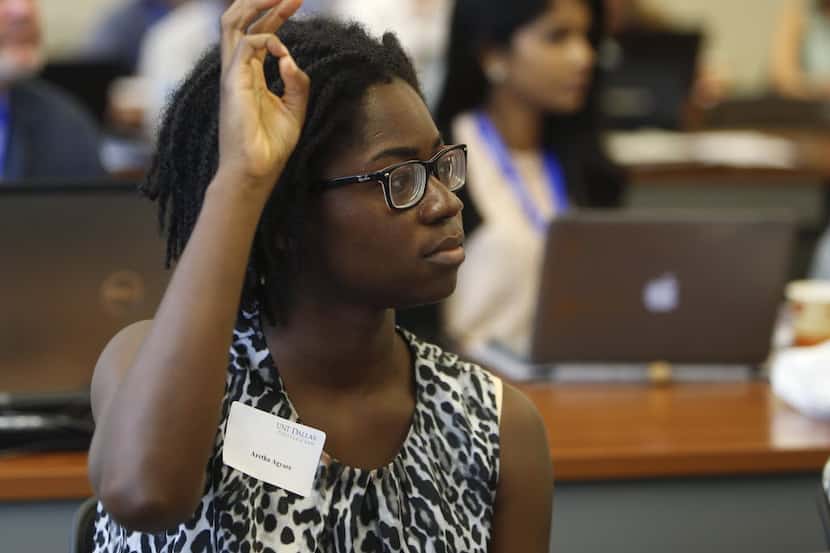 First-year law student Aretha Agyare raises her hand to ask a question during a lecture at...