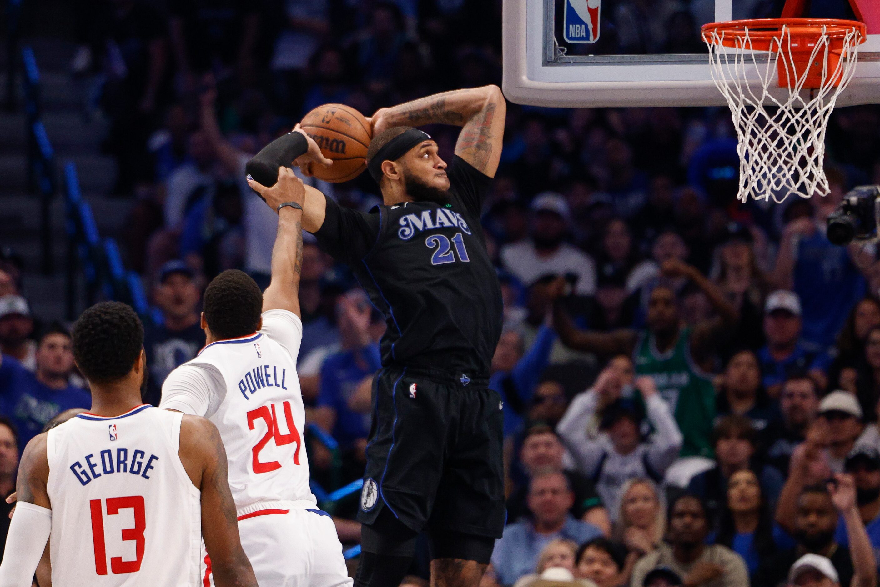 LA Clippers guard Norman Powell (24) fouls Dallas Mavericks center Daniel Gafford (21) as he...