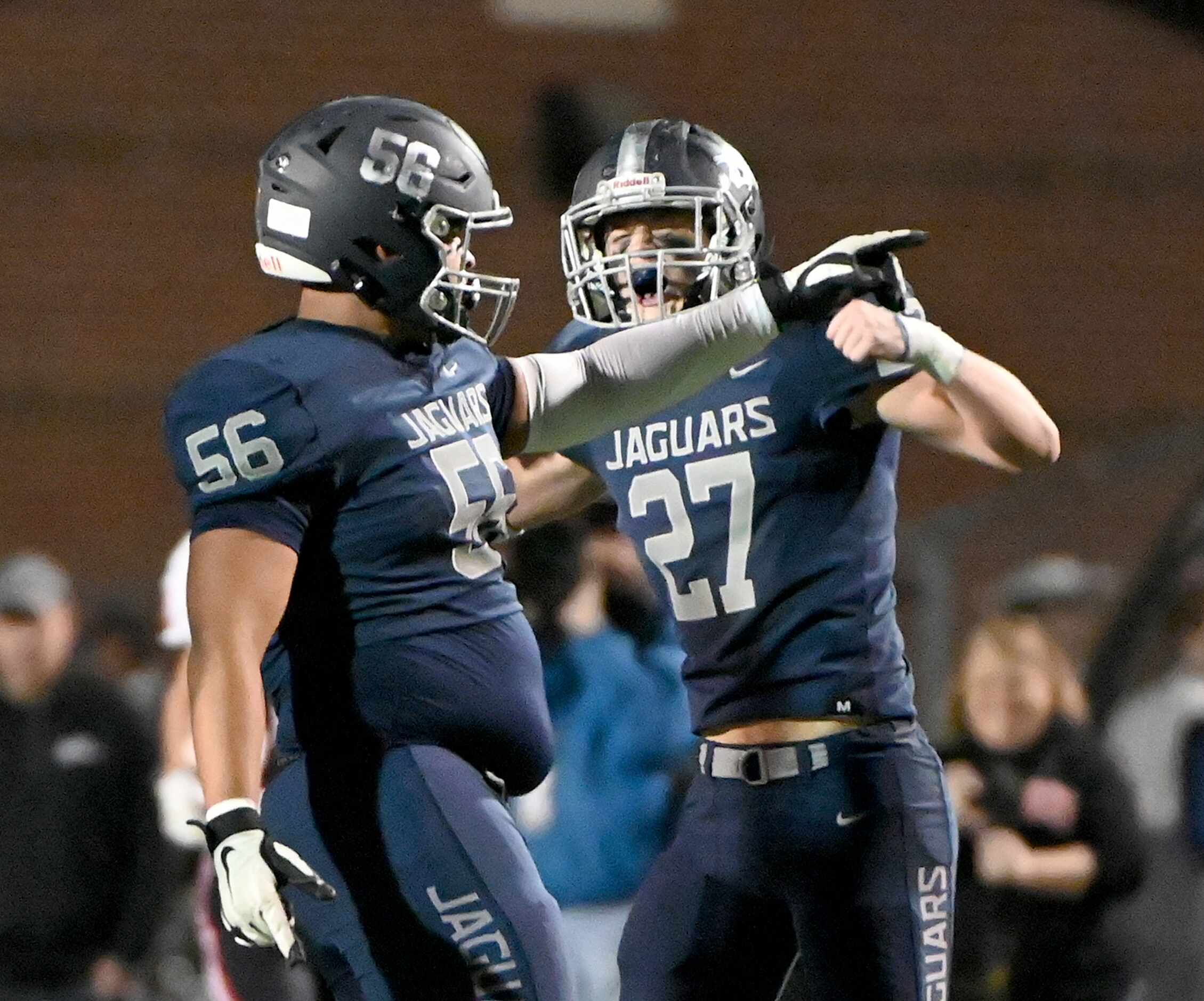 Flower Mound's Preston Lewis (56) and Rocco Cooper (27) celebrate after a sack in the first...