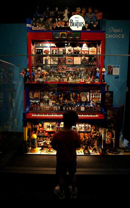 Knox MacFadyen, 4, looks at a collection of Beatles memorabilia, part of the Eye of the...