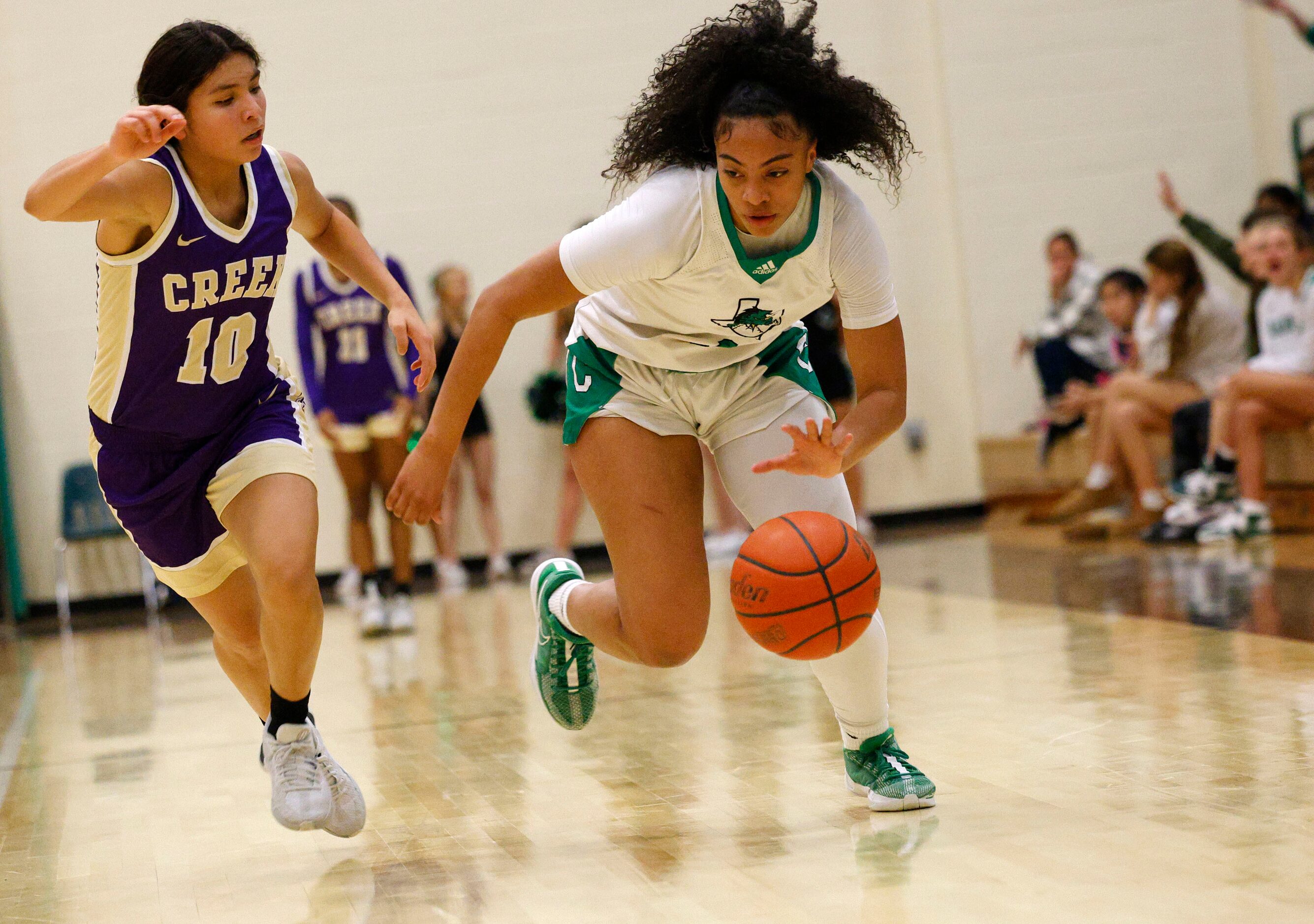 Southlake Carroll's Milania Jordan (1) keeps the ball away from Keller Timber Creek's Elena...