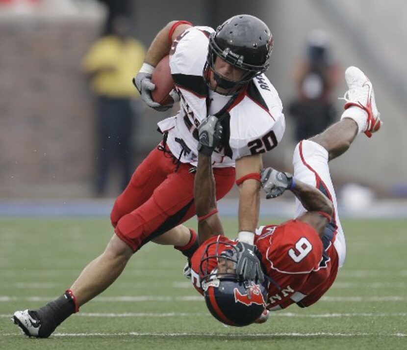 Texas Tech wide receiver Danny Amendola (20) knocks down SMU defensive back Bryan McCann (3)...