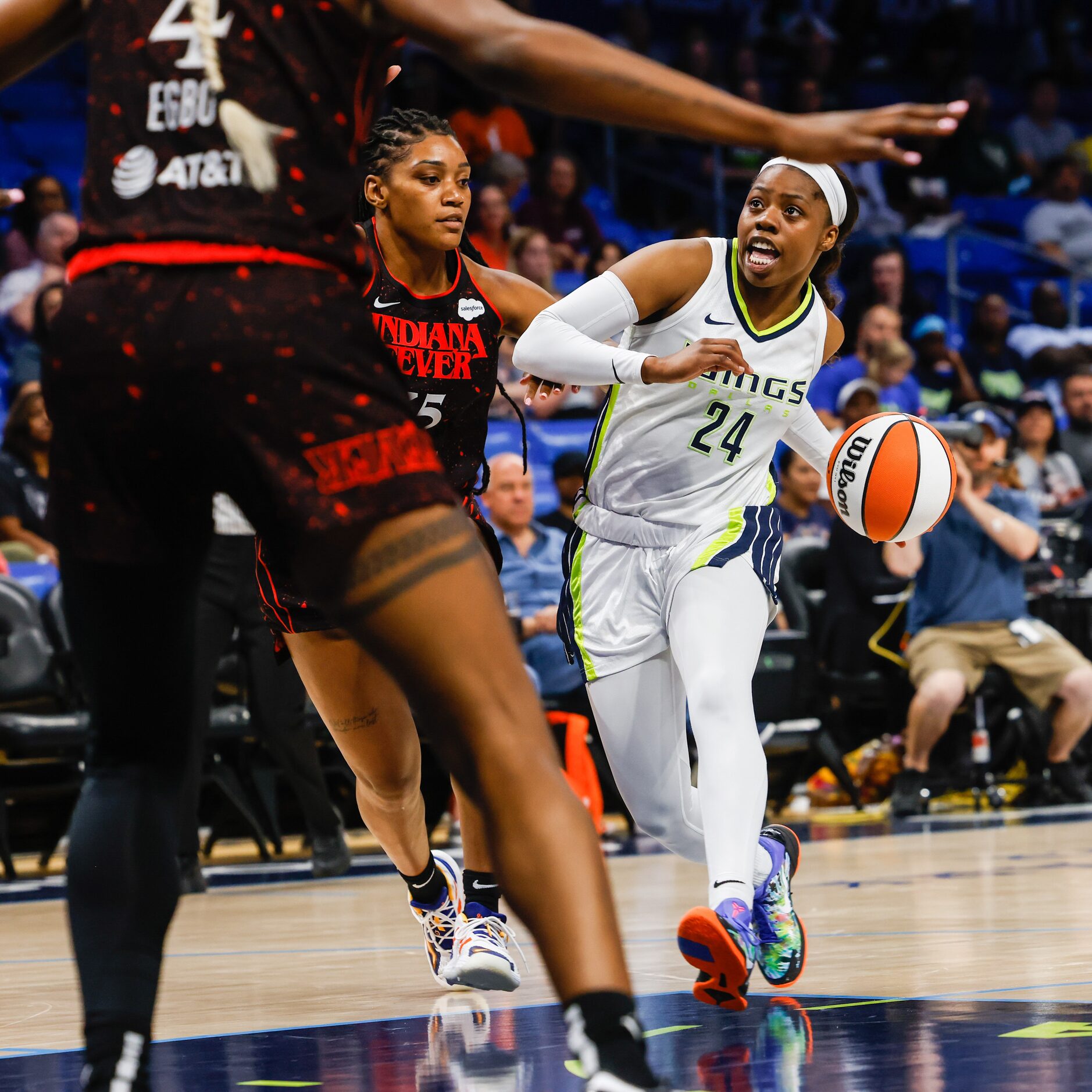 Dallas Wings guard Arike Ogunbowale (24) goes for a shot between Indiana Fever guard Tiffany...