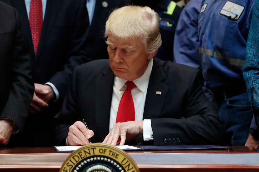 President Donald Trump signs H.J. Res. 38 in the Roosevelt Room of the White House in...