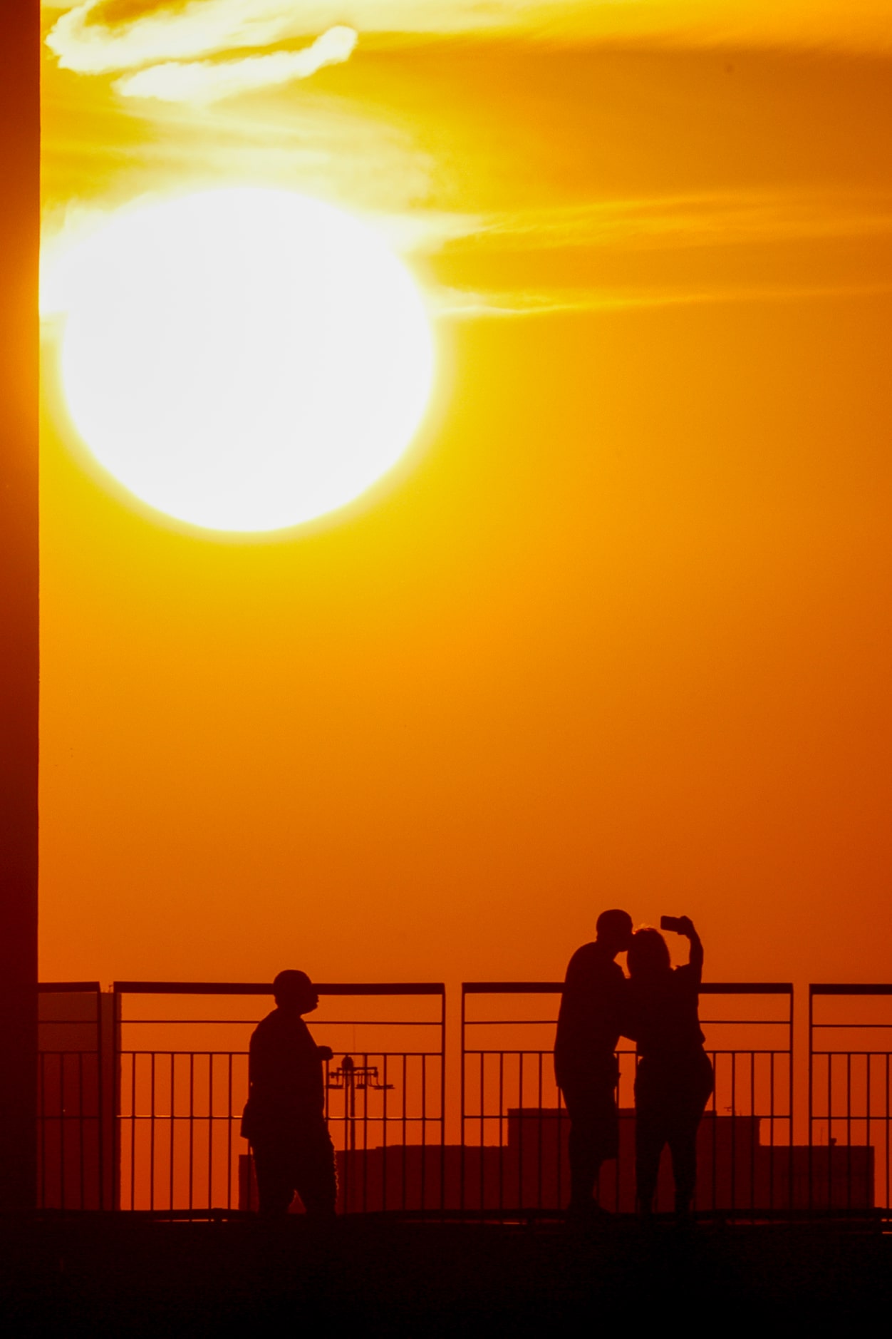 People take a selfie as the sun sets during the State Fair Classic between Prairie View A&M...