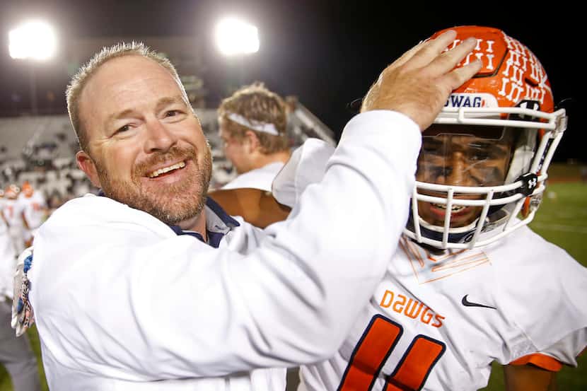 McKinney North head coach Mike Fecci (left) celebrates a 59-40 win over Little Elm with Toby...