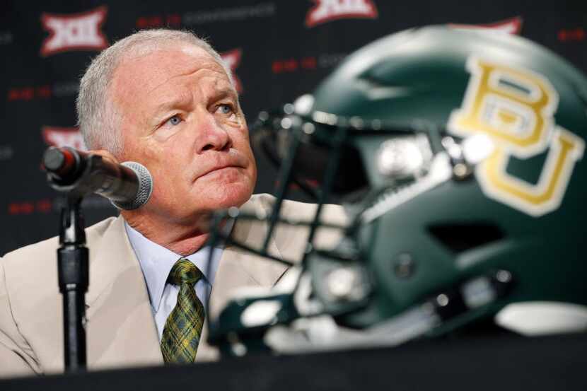 New Baylor head football coach Jim Grobe listens to a reporters question during the Big 12...