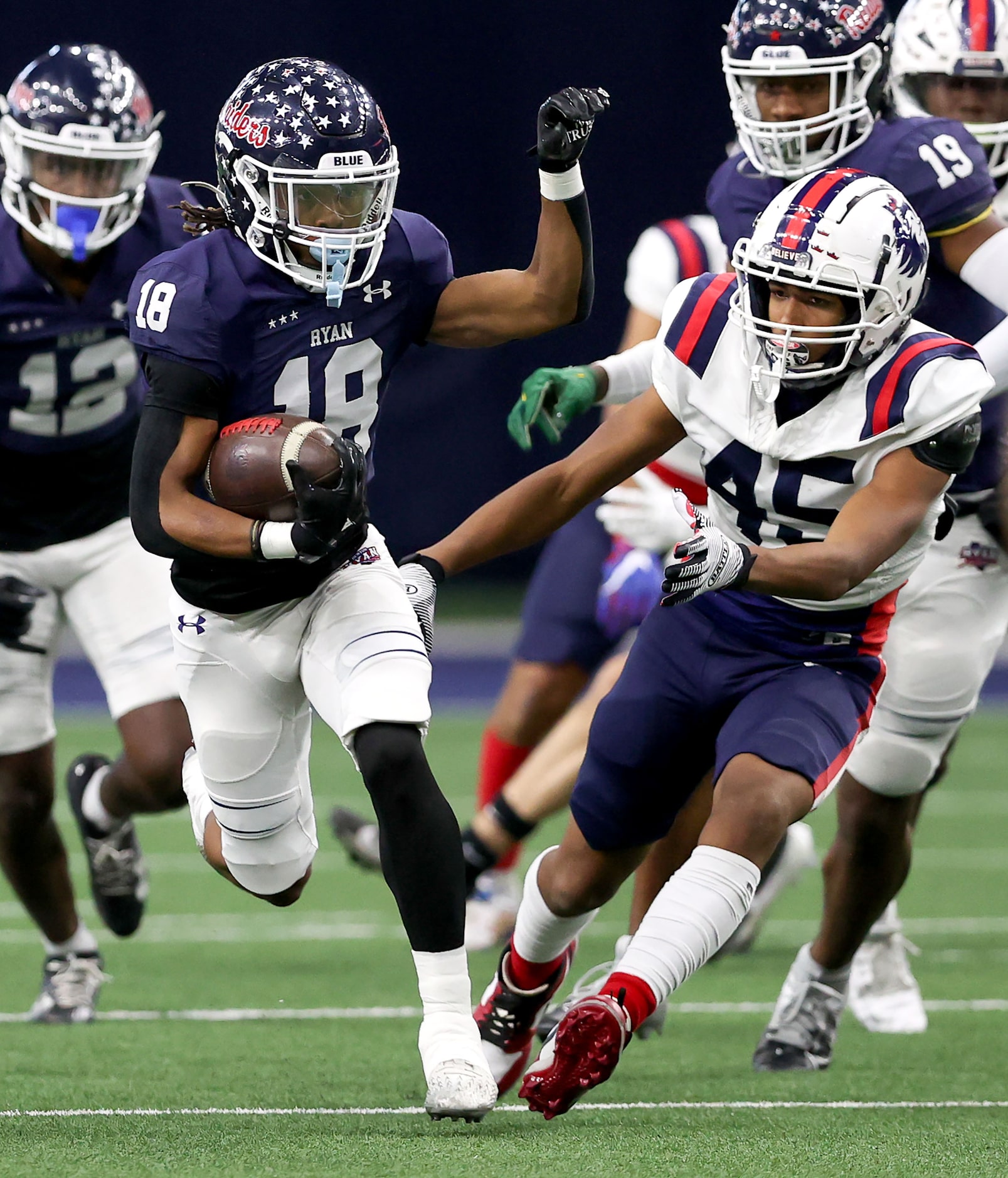 Denton Ryan kick returner Byran Simmons (18) tries to return a kickoff against Richland's...