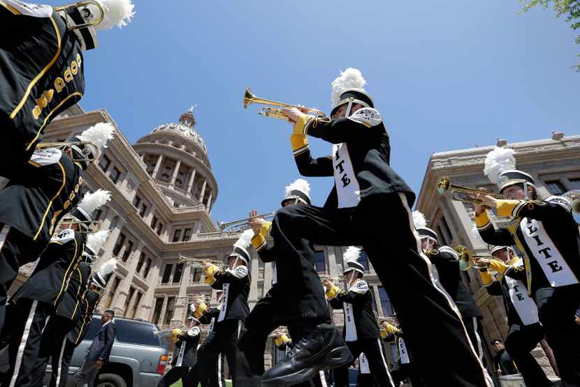 Members of the Elite College Prep Academy band from Houston march to the Texas Capitol for a...