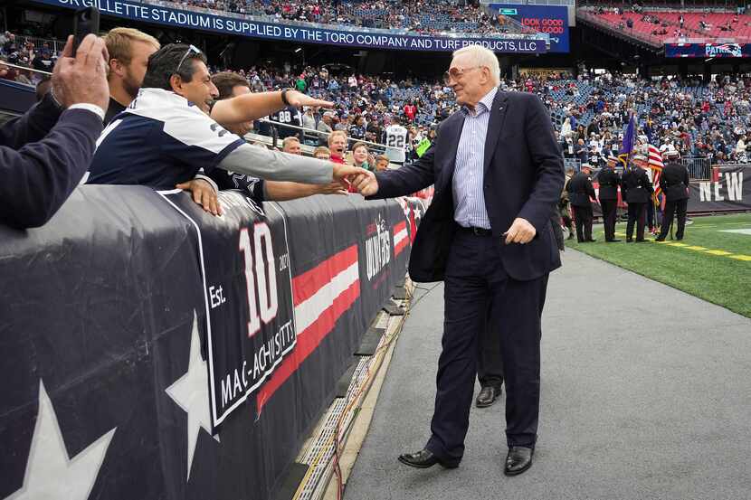 Dallas Cowboys owner and general manager Jerry Jones shakes hands with fans before an NFL...