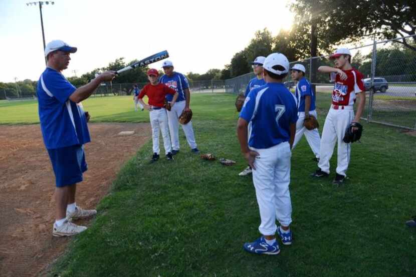 
Chris Corso, head coach of the Junior South Garland Allstars, talks to players during a...