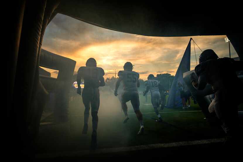 Frisco Lone Star players take the field to face Highland Park in a high school football game...