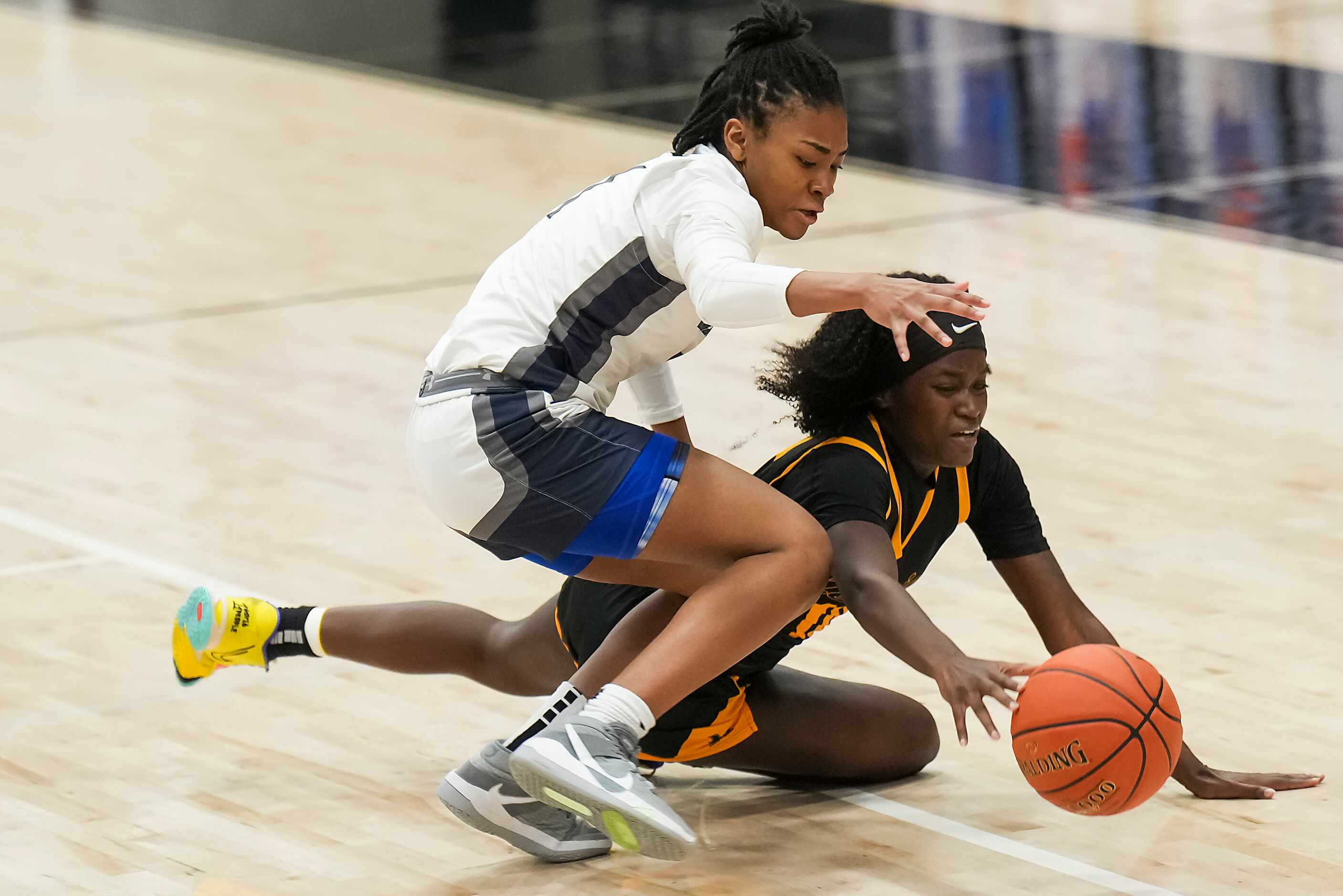 Frisco Memorial's Jasmyn Lott (10) fights for a loose ball against  Wylie East's Taylor...