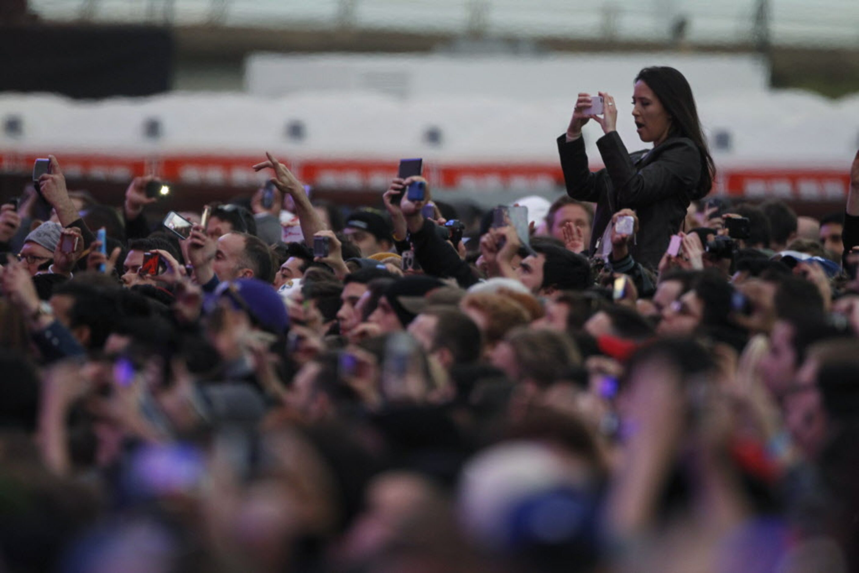 Fans take photos of The Killers during the March Madness Music Festival at Reunion Park in...