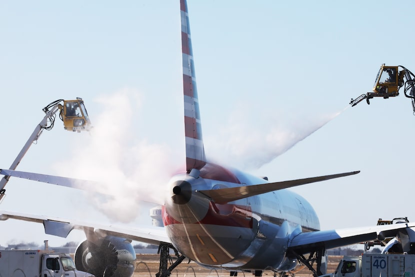 An American Airlines plane  goes through deicing procedures at Dallas Fort Worth...