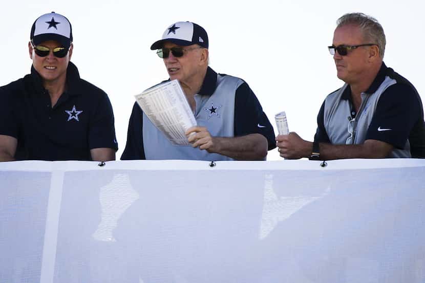 Dallas Cowboys owner Jerry Jones (center) watches practice from a tower with sons, and team...