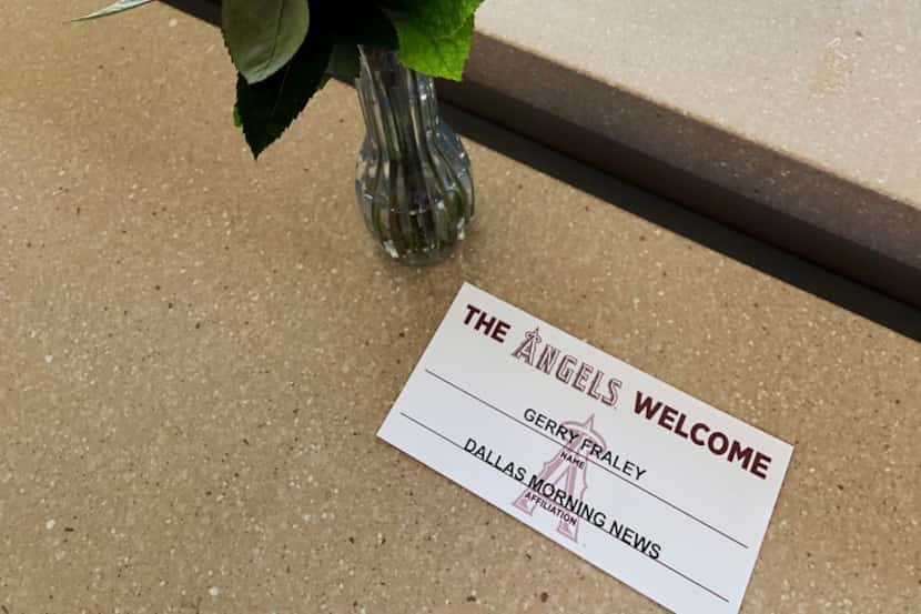 Roses and a place card hold a spot for sports reporter Gerry Fraley of The Dallas Morning...