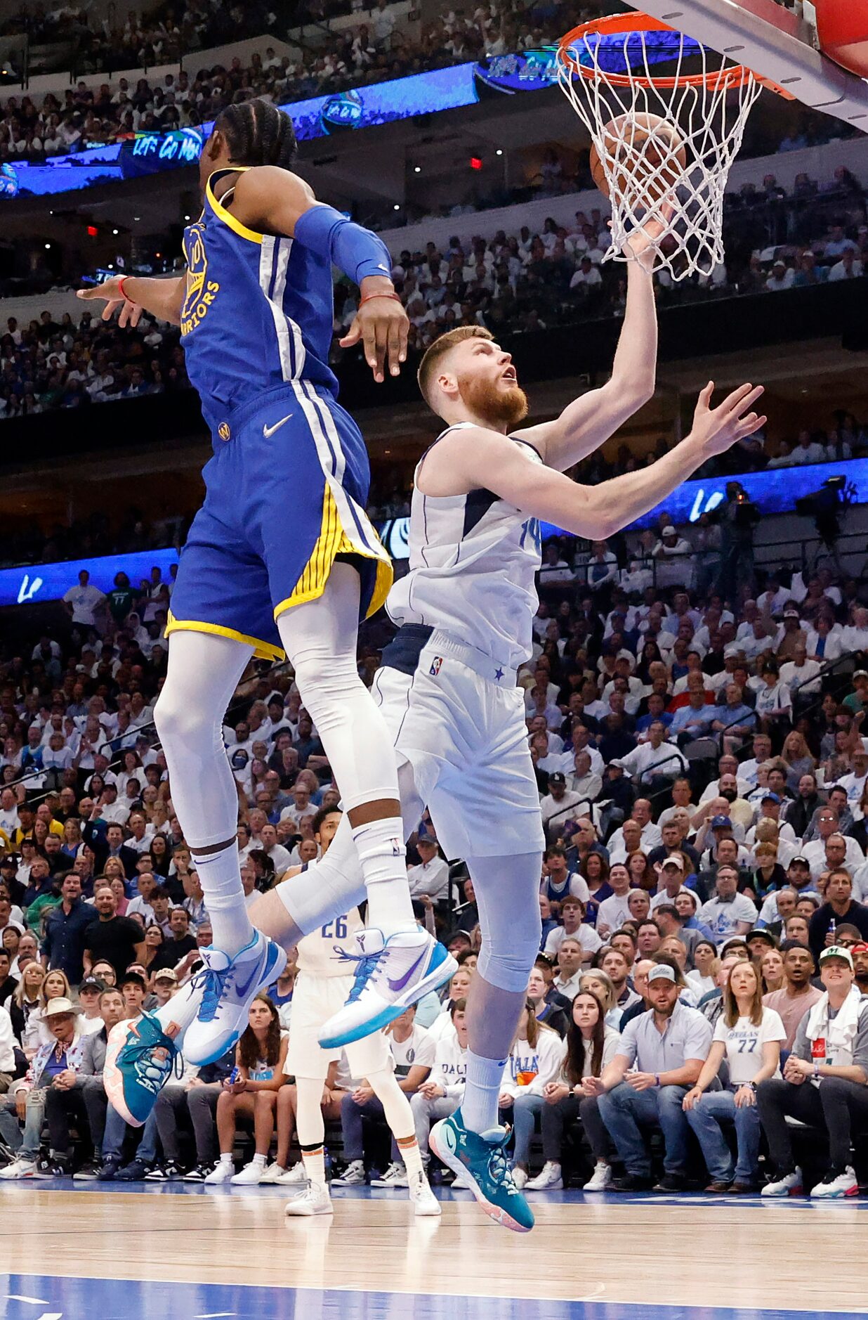 Dallas Mavericks forward Davis Bertans (44) puts up a shot under the basket against Golden...