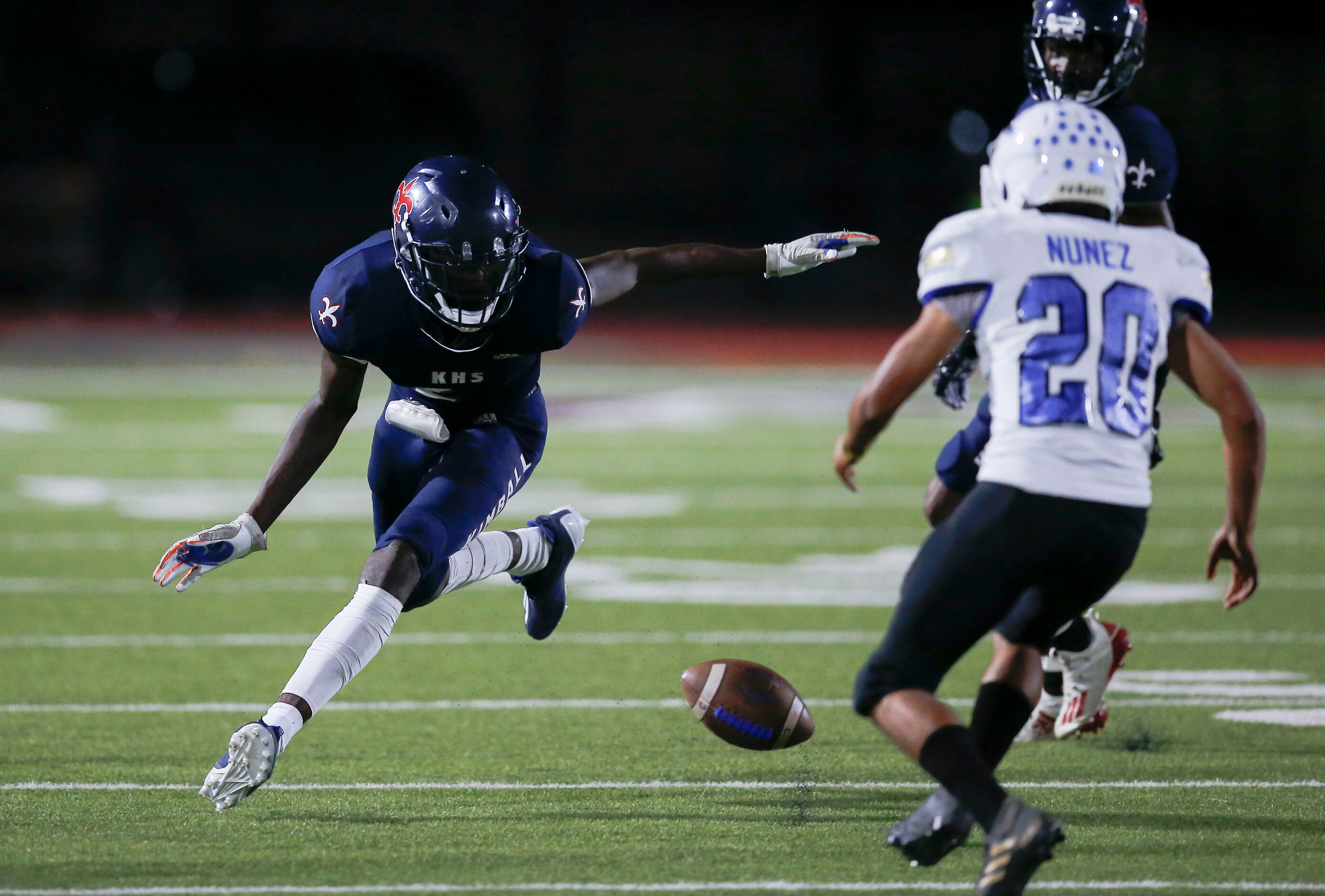 Kimball senior punt returner Kyron Henderson, left, fumbles the ball during the first half...