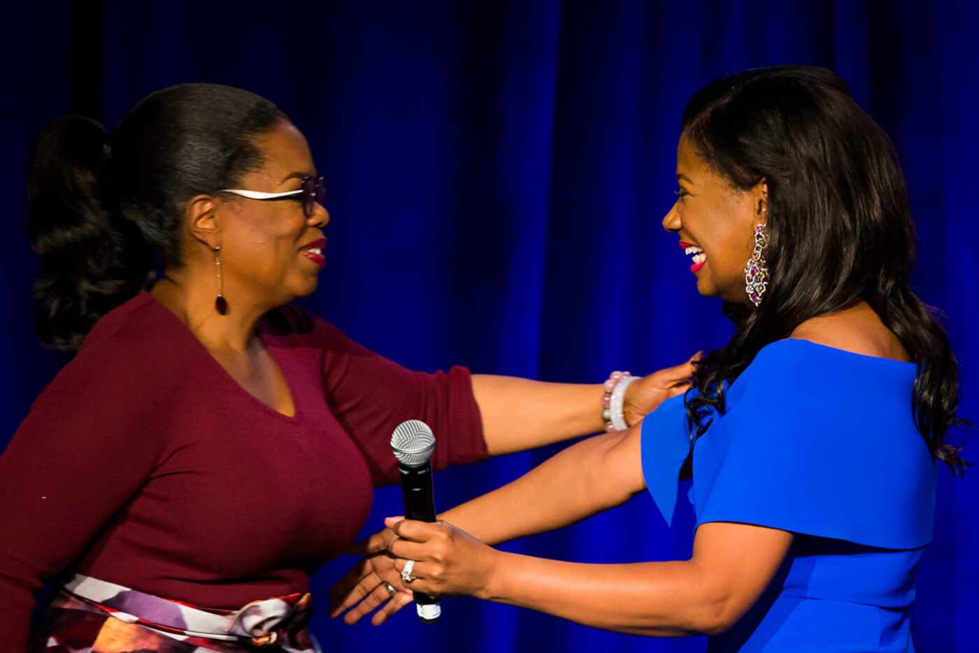 Oprah Winfrey (left) hugs founder Cheryl "Action" Jackson as she is introduced during the...