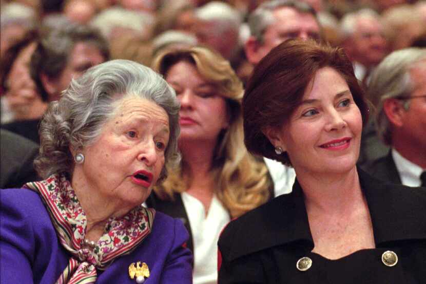 Former U.S. first lady Lady Bird Johnson, left, talks with Texas first lady Laura Bush...