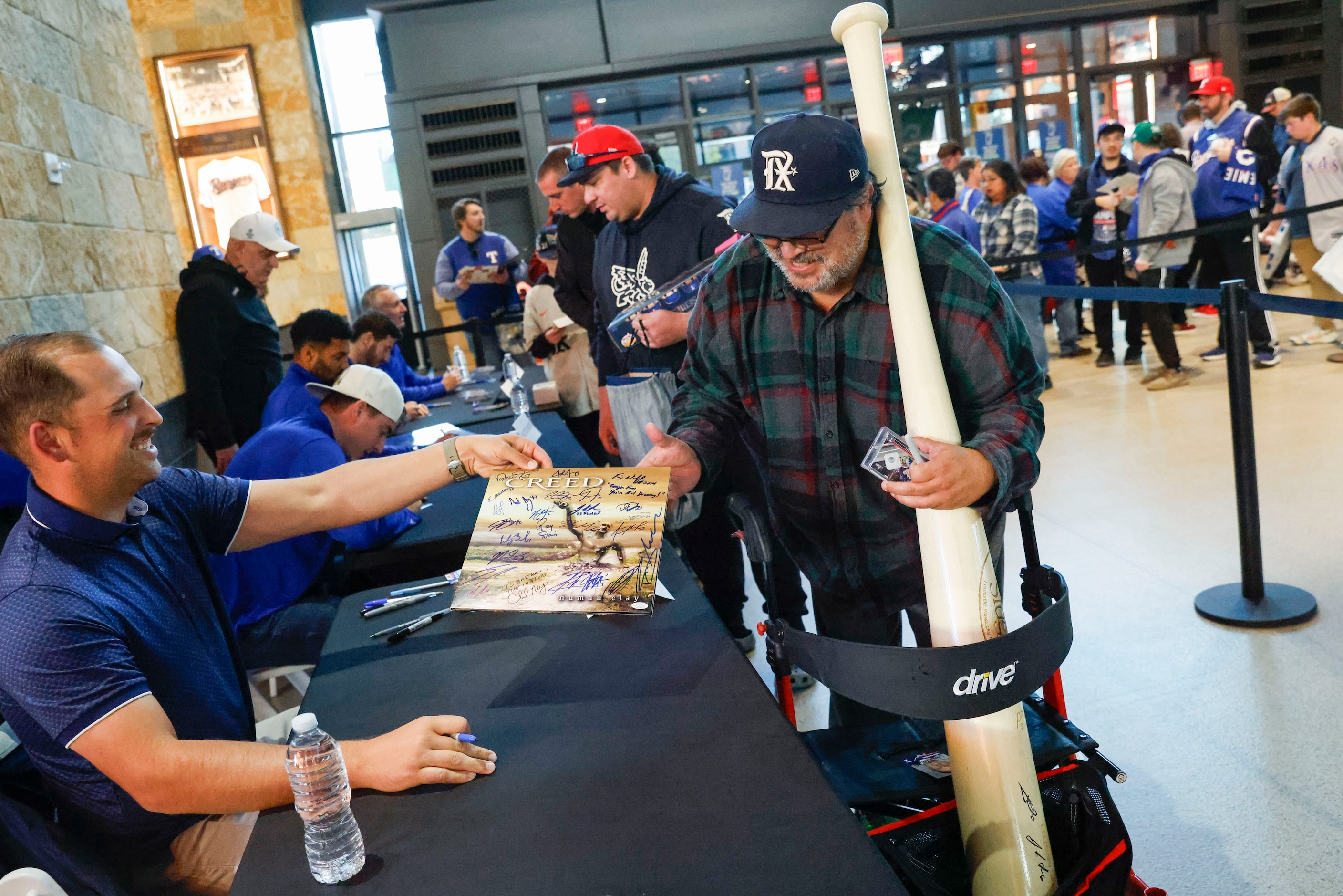 Texas Rangers first baseman Nathaniel Lowe gives an autograph to Mike Navarro of Waxahachie...