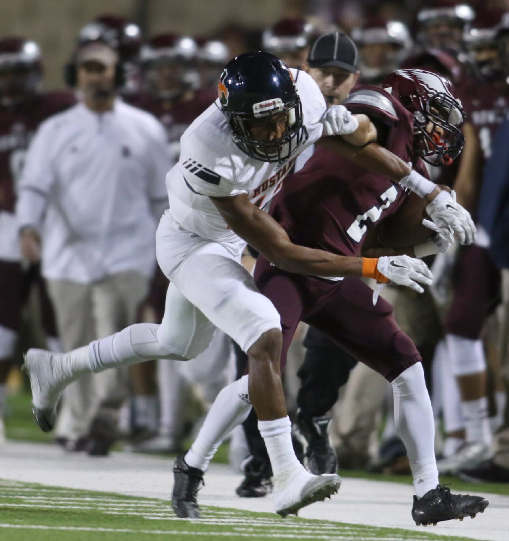 Rowlett receiver Josh Lewis (2) takes a hard hit from Sachse defender Godfrey Okoye (17),...