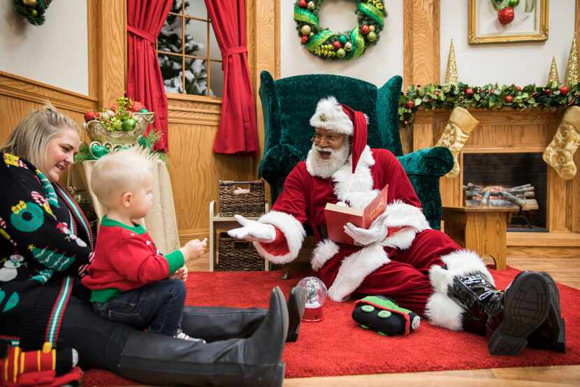 Santa Larry Jefferson interacts with 20-month-old Shea and his mother Sarah Barth of St....